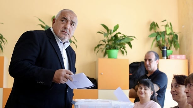 Leader of the GERB party and former Prime minister Boyko Borisov (L) looks on as he casts his ballot at a polling station during Bulgaria's parliamentary elections in Sofia on April 19, 2026. Bulgarians vote in the country's eighth election in five years today, with ex-president Rumen Radev's groupi
