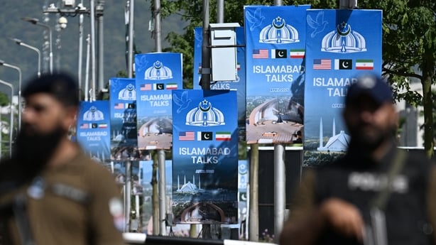 Security personnel stand guard at a security checkpost along a road temporarily closed near the Serena Hotel at the Red Zone area in Islamabad on April 20, 2026, ahead of anticipated US-Iran peace talks. Iran is not currently planning to attend talks with the United States, state media said, after P