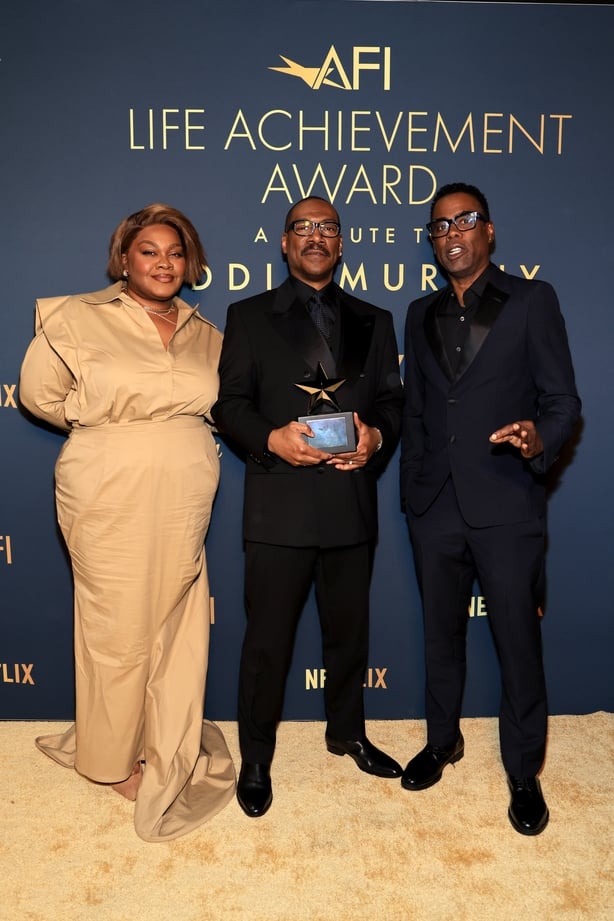 (L-R) Da'Vine Joy Randolph, Eddie Murphy, posed with AFI Lifetime Achievement award, and Chris Rock attend the 51st AFI Life Achievement Award: A Tribute To Eddie Murphy at Dolby Theatre on 18 April, 2026 in Hollywood, California. (Photo by Savion Washington/Getty Images for AFI)