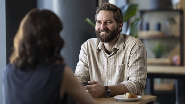 Daryl (Rick Donald) smiles talking to Shiv (Róisín Gallagher) in The Dry