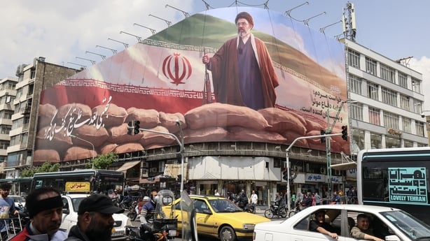 Commuters drive past a large billboard depicting Iran's Supreme Leader Ayatollah Mojtaba Khamenei on a street in Tehran on April 20, 2026