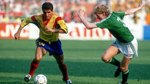 Romania's Gheorghe Hagi gets away from Republic of Ireland's Stve Staunton during the 1990 World Cup clash in Genoa