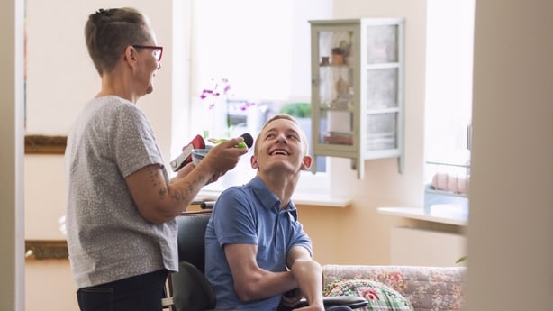 Young physically impaired Cerebral Palsy patient being fed by his mother.