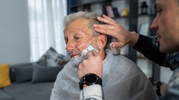 Volunteer in home visit at senior man