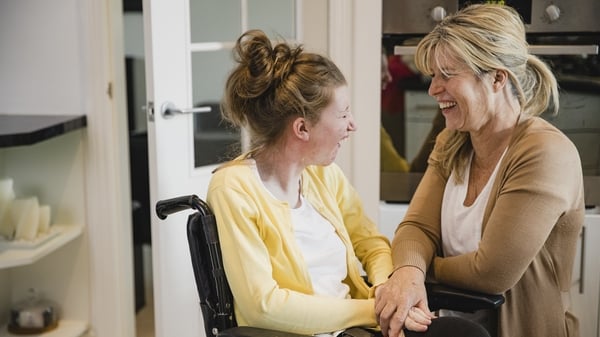 Mature mother is relaxing in the kitchen with her daughter