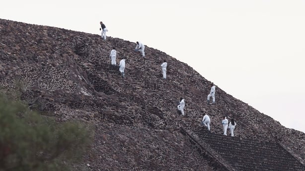 Forensic experts work on the Pyramid of the Moon following a shooting 