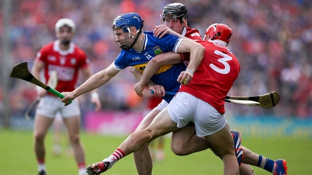 19 April 2026; John McGrath of Tipperary is tackled by Robert Downey and Ciarán Joyce of Cork during the Munster GAA Senior Hurling Championship Round 1 match between Tipperary and Cork at FBD Semple Stadium in Thurles, Tipperary. Photo by Brendan Moran/Sportsfile