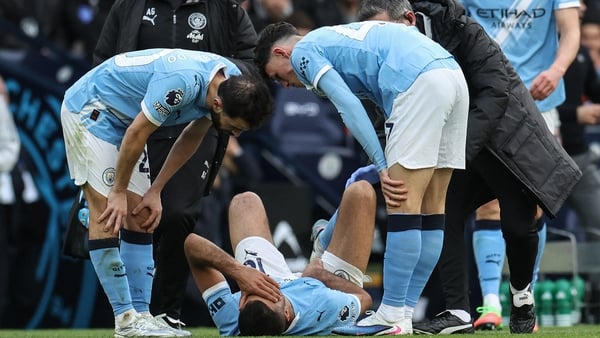 Manchester City's Spanish midfielder #16 Rodri (C-on ground) reacts after being injured during the English Premier League football match between Manchester City and Arsenal at the Etihad Stadium in Manchester, north west England, on April 19, 2026.