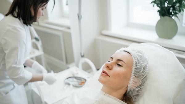 female client waiting for injection procedure for facial rejuvenation