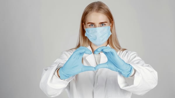 Medical professional making a heart shape with her hands