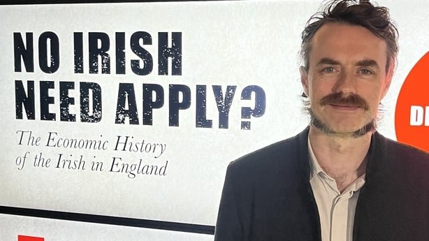 Prof Neil Cummins in front of a sign at EPIC