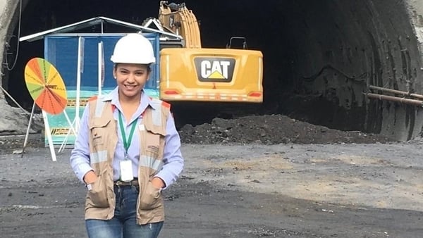 Lorena Prasca Ramirez standing near building machinery