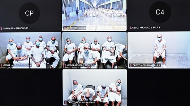 Monitors broadcast the mass hearing against alleged leaders of the Mara Salvatrucha (MS-13) at the Judicial Center Against Organized Crime in Soyapango, El Salvador,