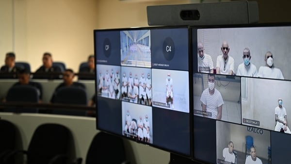 Monitors broadcast the mass hearing against alleged leaders of the Mara Salvatrucha (MS-13) at the Judicial Center Against Organized Crime in Soyapango, El Salvador, on April 20, 2026. Nearly 490 alleged members of the powerful Central American gang Mara