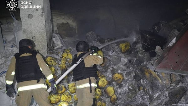 Rescuers work at the site of a Russian drone strike on odea port