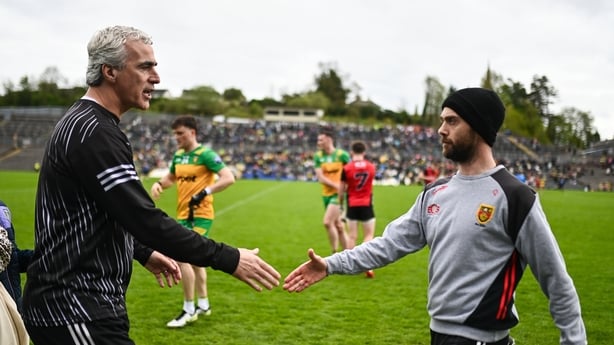 Donegal manager Jim McGuinness, left, and Down manager Conor Laverty 