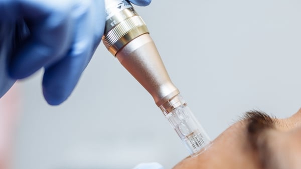 Close up of cosmetologist holding tool with needle