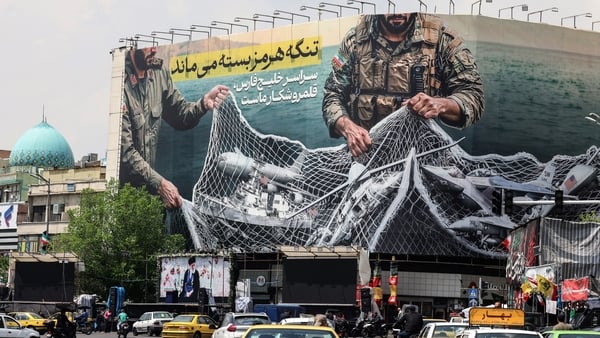 A giant billboard reading 'the strait of hormuz remains closed'