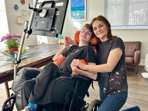 Luke Miggin, who suffered brain damage at birth, with his mother, Emily