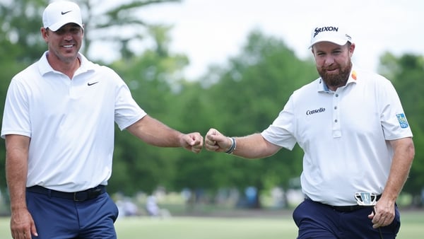 AVONDALE, LOUISIANA - APRIL 23: Brooks Koepka (L) of the United States and Shane Lowry of Ireland react after Lowry's birdie on the fourth hole during the first round of the Zurich Classic of New Orleans 2026 at TPC Louisiana on April 23, 2026 in Avondale