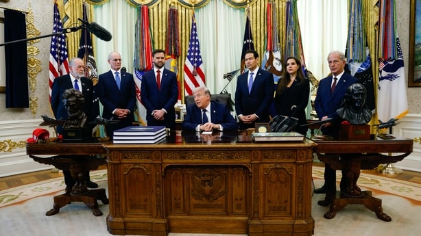 People crowd around a tabe