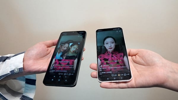 Phones displaying screenshots of a video from Chinese model and influencer Christine Li accusing an AI microdrama of stealing her likeness