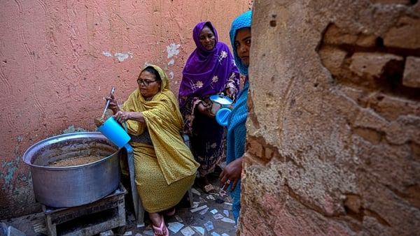 Sudanese women prepare free meal canisters at the home of the founder of the “Community Kitchen” initiative in Omdurman on April 21, 2026. The top United Nations official in Sudan told AFP on April 16, 2026, that the country, facing the world's largest hu