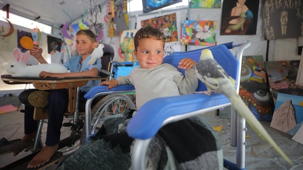 Palestinian children play with animals at the rehabilitation space in the Nuseirat Refugee Camp, founded by displaced Palestinian man Rashid Anbar, in Deir al Balah, Gaza