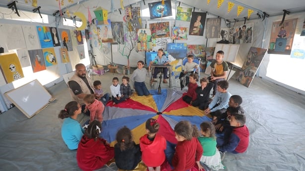 Palestinian children play with animals at the rehabilitation space in the Nuseirat Refugee Camp