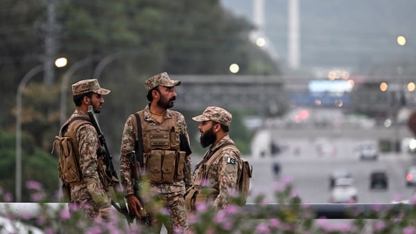 Pakistan’s army soldiers stand guard on a street leading to the Red Zone area after tightened security measures ahead of the expected US–Iran peace talks in Islamabad on April 24, 2026. Iran's state media confirmed that Foreign Minister Abbas Araghchi wou