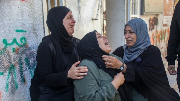 Amnaa al-Abed (C) mourns during the funeral of her sons, Salah and Abdullah, killed in a reported Israeli airstrike the previous night, at al-Shifa Hospital on 23 April 