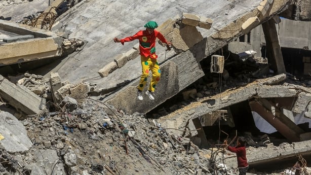 A group of volunteers wearing clown costumes try to entertain the Palestinian children during an event for children affected by Israeli attacks, in Khan Younis, Gaza, Palestine 