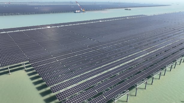 Construction workers conduct offshore operations at the construction site of the CNNC Tianwan mudflat Photovoltaic Demonstration Project in Lianyungang City, Jiangsu Province, China, on April 19, 2026. (Photo by Costfoto/NurPhoto via Getty Images)