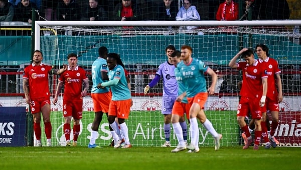 Shelbourne players, including, Paddy Barrett, left, and Kameron Ledwidge, second from left, react after their side concede a goal scored by Drogheda United's Edwin Agbaje