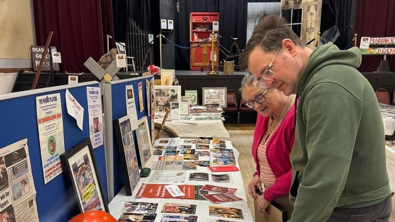 People look at memorabilia on a table