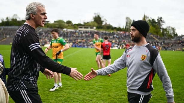 Donegal manager Jim McGuinness, left, and Down manager Conor Laverty shake hands after the Ulster GAA Football Senior Championship semi-final match between Down and Donegal at St Tiernach's Park in Clones, Monaghan.