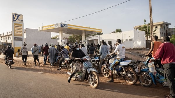 Motorcyclists line up to get fuel at one of the few petrol stations with supply in Bamako on December 10, 2025.
