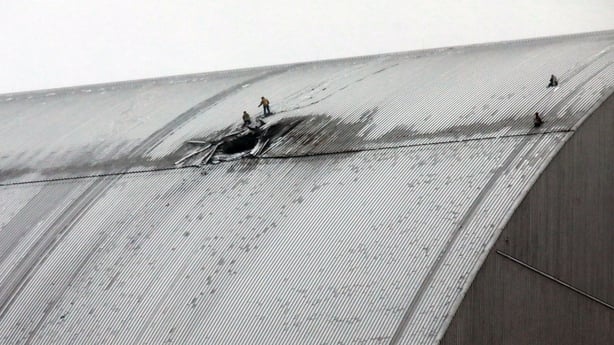 Rescuers work at the site where a Russian attack drone with an explosive warhead hits the New Safe Confinement at the Chornobyl Nuclear Power Plant in the Kyiv region, Ukraine, on January 14, 2025. The structure, put in place in 2016, protects the remains of Reactor 4 destroyed during the 1986 Chorn