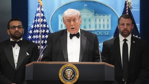US President Donald Trump speaks during a press conference while flanked by FBI Director Kash Patel and Secretary of Homeland Security Markwayne Mullin in the Briefing Room of the White House.