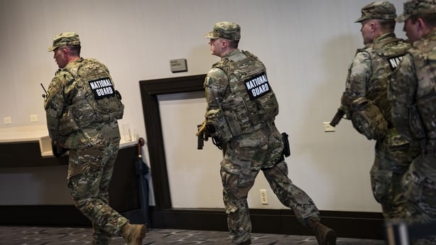 WASHINGTON, DC - APRIL 25: Members of the National Guard respond with weapons drawn at the Washington Hilton after the White House Correspondents Association Dinner was postponed on April 25, 2026 in Washington, DC. U.S. President Donald Trump, first lady Melania Trump, Vice President JD Vance and o