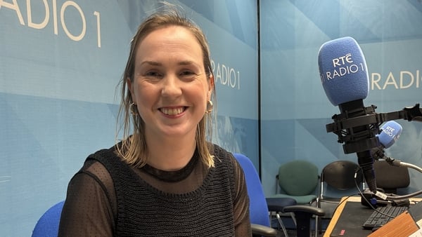 writer Niamh Donnelly behind the mic, smiling to camera, in RTÉ Radio studio, for Sunday Miscellany, April 2026