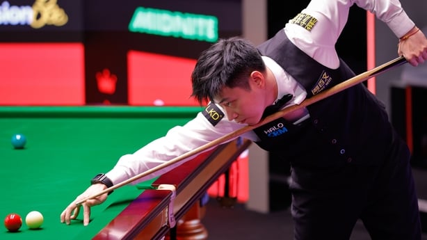 Zhao Xintong of China plays a shot in the second round match against Ding Junhui of China on day 8 of Halo World Championship 2026 at Crucible Theatre on April 25, 2026 in Sheffield, England.