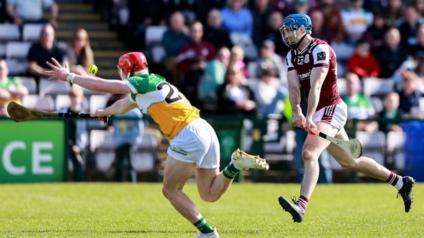 Conor Cooney of Galway on his way to scoring his side's first goal despite the attention of Ruairí Kelly of Offaly during the Leinster GAA Senior Hurling Championship Round 2 match between Galway and Offaly at Pearse Stadium in Galway. 