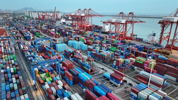 Containers and ships are seen at the port in Lianyungang, in China’s eastern Jiangsu province early on April 23, 2026. (Photo by CN-STR / AFP) / China OUT