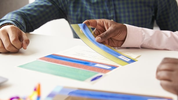 Close Up Of Student With Dyslexia Using Colored Overlays