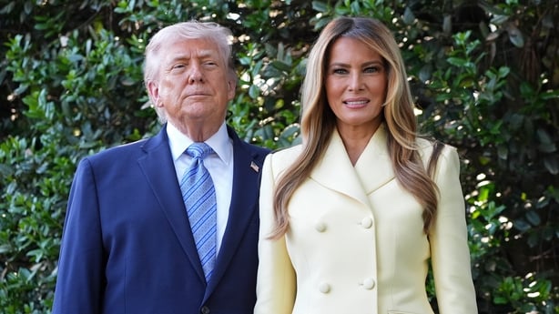 Donald Trump and first lady Melania Trump poses for a photo at the White House bee hive