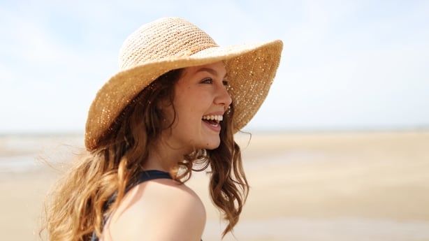 woman wearing sunhat on a beach