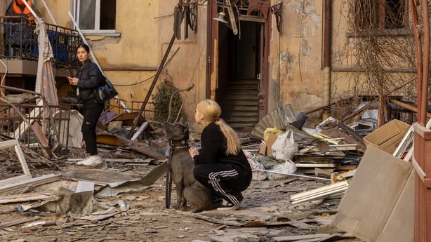 ODESA, UKRAINE - APRIL 27: A woman with dog stands amid debris in the yard of damaged residential building after Russian drone attack on April 27, 2026 in Odesa, Ukraine. As of this morning, 11 people have been injured, including 2 children. All are receiving necessary medical care. Cars, residentia