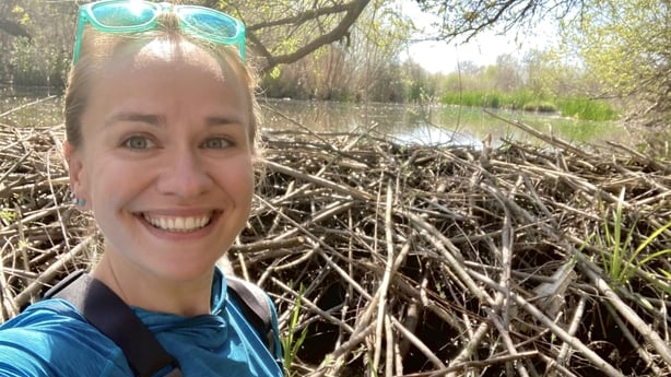 Dr Emily Fairfax takes a selfie in front of a beaver dam