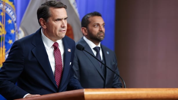 Acting Attorney General Todd Blanche speaks as FBI Director Kash Patel listens at a press conference on April 28, 2026 at the Department of Justice in Washington, DC. Charges were brought against former FBI Director James Comey on Tuesday in an investigation over a photo of seashells arranged on a b